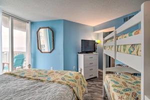 a bedroom with blue walls and a bunk bed and a mirror at Colorful Beachfront Condo with Resort Amenities in North Topsail Beach +22 photos