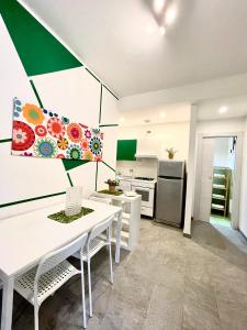 a kitchen with a white table and chairs in a room at Casa Serra in Porto Palo