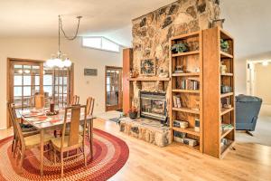 a dining room and living room with a fireplace at 40-Acre Poplar Bluff Nature Lovers Paradise! in Poplar Bluff