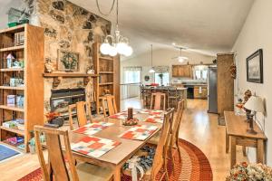 a dining room with a table and a stone wall at 40-Acre Poplar Bluff Nature Lovers Paradise! in Poplar Bluff