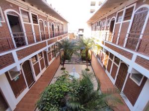 an empty courtyard of a building with trees and plants at Hotel Js in Alfenas