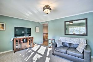 a living room with a couch and a television at Cottage 3 Miles to Dwntwn and Bangor Waterfront 
