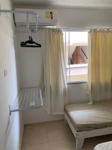 a room with a bunk bed and a window at Residencial L & L in Guaratuba