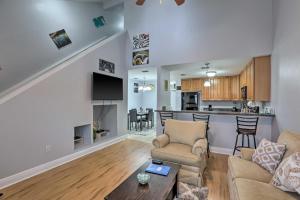 a living room with a couch and a table at Tidy Tallahassee Townhome about 7 Mi to Downtown! in Tallahassee