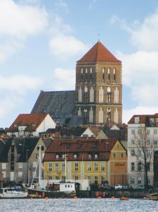 a large building with a tower on top of a city at Hotel Altes Hafenhaus in Rostock