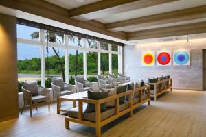a dining room with chairs and a table and windows at Hot Cross Point Santa Monica in Miyako Island
