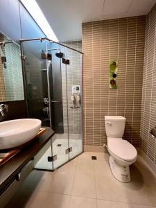 a bathroom with a toilet and a sink and a shower at Zhi Da Craft Service Guest House in Caotun