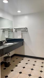 a bathroom with two sinks and a mirror at Capital City Inn Downtown Convention Center in Sacramento