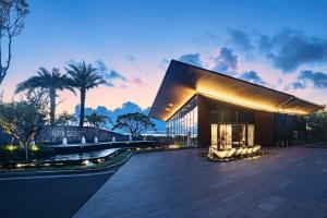 a rendering of a building with a sunset in the background at The Yun Resort Shenzhen Longcheer in Shenzhen
