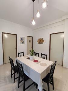 a dining room with a white table and chairs at Dream 2 in Cameron Highlands