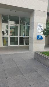 a building with a sign on the side of it at Flat Beira Mar JTR Action in Maceió