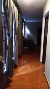 a hallway of a living room with curtains at Hotel Suites La Fortuna in Mazamitla