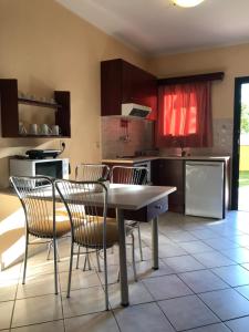 a kitchen with a table and chairs in it at Leremo Luxury Messonete in Roda