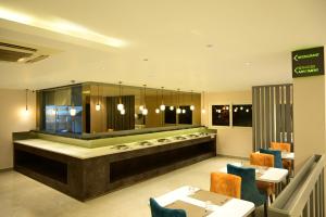 a restaurant with tables and chairs and a counter at Sterling Keys by TGI in Bangalore
