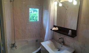 a bathroom with a tub and a sink and a mirror at Hôtel Saint Alban in Saint-Maur-des-Fossés +34 photos
