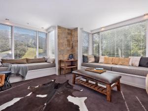 a living room with two couches and a table at Big Nanook Squatters 32 in Thredbo