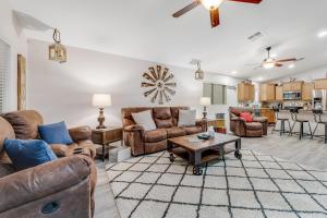 a living room with leather furniture and a table at Sunrise Windmill in Sun City