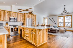 a kitchen with wooden cabinets and a large center island at Steel Lane Hideaway in Government Camp