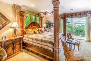 a bedroom with a large wooden bed and a window at Eagles Nest at Big Bear Estates in Waynesville