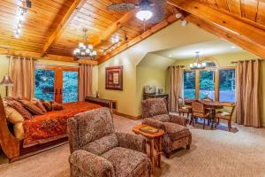 a bedroom with a bed and a table and chairs at Eagles Nest at Big Bear Estates in Waynesville