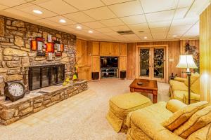 a large living room with a stone fireplace at Eagles Nest at Big Bear Estates in Waynesville