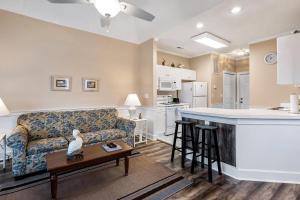 a living room with a couch and a kitchen at Myrtle Beach Getaway 1 in Myrtle Beach