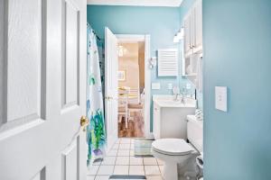a blue bathroom with a toilet and a sink at Myrtle Beach Getaway 1 in Myrtle Beach