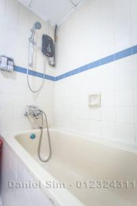 a bathroom with a shower and a bath tub at Bayu Beach Resort Apartment Seaview Private Beach in Port Dickson +91 photos