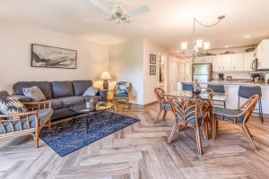 a living room with a couch and a table at Maui Kamaole M104 in Wailea