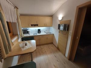 a small kitchen with a table and a microwave at Haus Rosa in Kartitsch