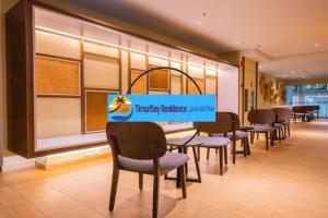 a row of chairs and tables in a waiting room at TimurBay Seafront Holiday Pool & Seaview in Kuantan +56 photos