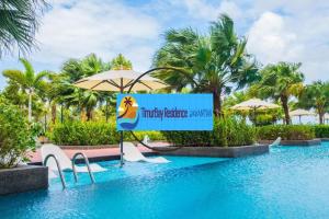 a sign in the middle of a swimming pool at a resort at TimurBay Seafront Holiday Pool & Seaview in Kuantan