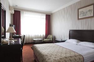 a hotel room with a bed and a desk at Gurkent Hotel in Ankara