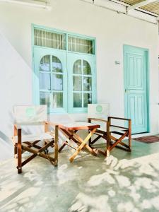 a table and two chairs in a room at Indie Beach Bungalows in Ko Chang