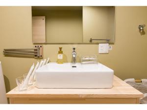 a white sink in a bathroom with a mirror at 桃月庵 -Togetsuan- in Osaka +37 photos
