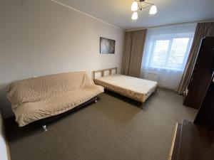 a small bedroom with a bed and a window at Dekabrist Apartment at Kirova 16 in Chita