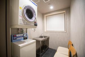 a small bathroom with a sink and a washing machine at Karasuma Rokujo Hotel / Vacation STAY 3038 in Kyoto