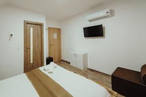 Postel nebo postele na pokoji v ubytování Pensiunea Smiley