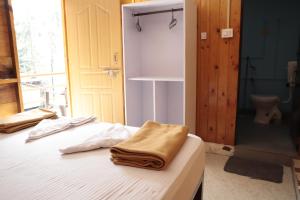 a bedroom with a bed with towels on it at ORANGE SKY INN HOLIDAY HOME in Canacona +100 photos