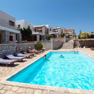 a swimming pool in a villa with two people in the water at Malvazios Villas #8 in Mavrovouni
