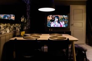 een eetkamer met een tafel met stoelen en een tv bij Apartment Levi Star 1204 in Levi