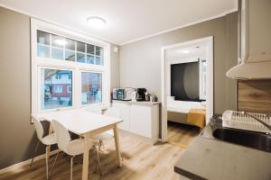 a kitchen and dining room with a table and chairs at Villa Svolvær in Svolvær