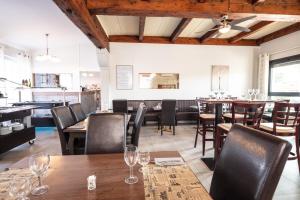 a dining room with wooden tables and chairs at Auberge de la Tour -Appartements- in Valros