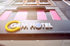 a sign on the side of a building with the cimmel logo at Gem Hotel Nusa Sentral Nusajaya in Johor Bahru