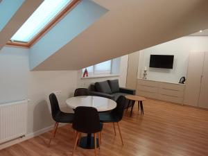 a living room with a table and chairs at Apartamenty Radom Klwatecka 20 in Radom