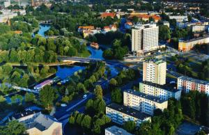 an aerial view of a city with a river and buildings at Hotel Gromada Pila in Piła