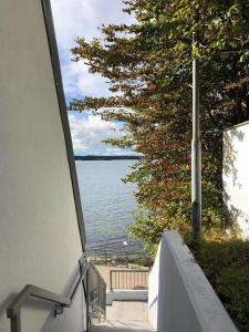 a balcony with a view of the water at Ferienwohnung Fördeglück in Glücksburg