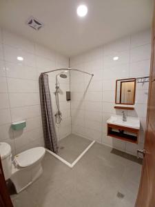 a bathroom with a shower and a toilet and a sink at Kenting Ocean World Diving II in Hengchun