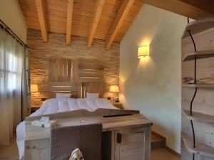 a bedroom with a large bed with white pillows at Hotel Bait de Angial in Livigno