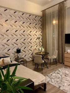 Televízia a/alebo spoločenská miestnosť v ubytovaní Marble